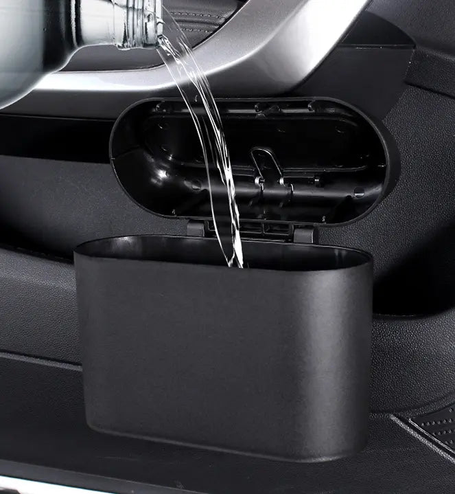 Collapsible Car Bin mounted in a car door pocket, hand dropping in a wrapper