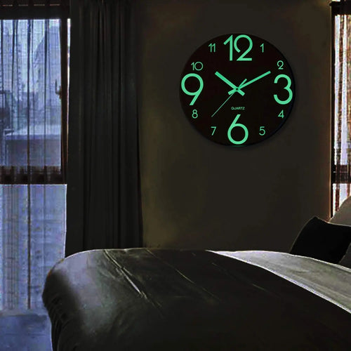 Nordic Glow Wall Clock glowing softly on a bedroom wall at night