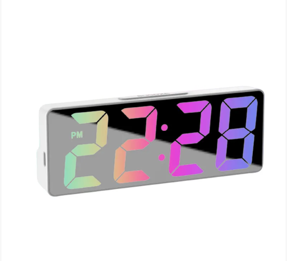 Lucent Mirror Alarm Clock on a bedside table at night, PM indicator visible