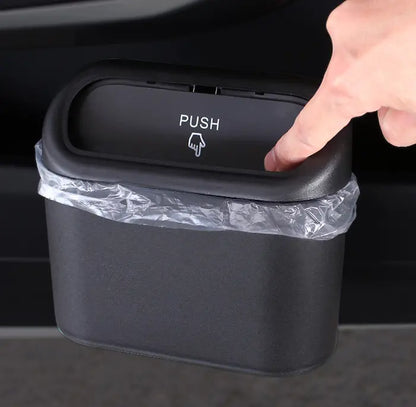 Collapsible Car Bin mounted in a car door pocket, water being poured in during use
