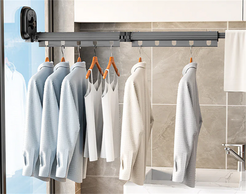 Fold-Away Drying Rack mounted in a bathroom, fully extended with clothes hanging to dry